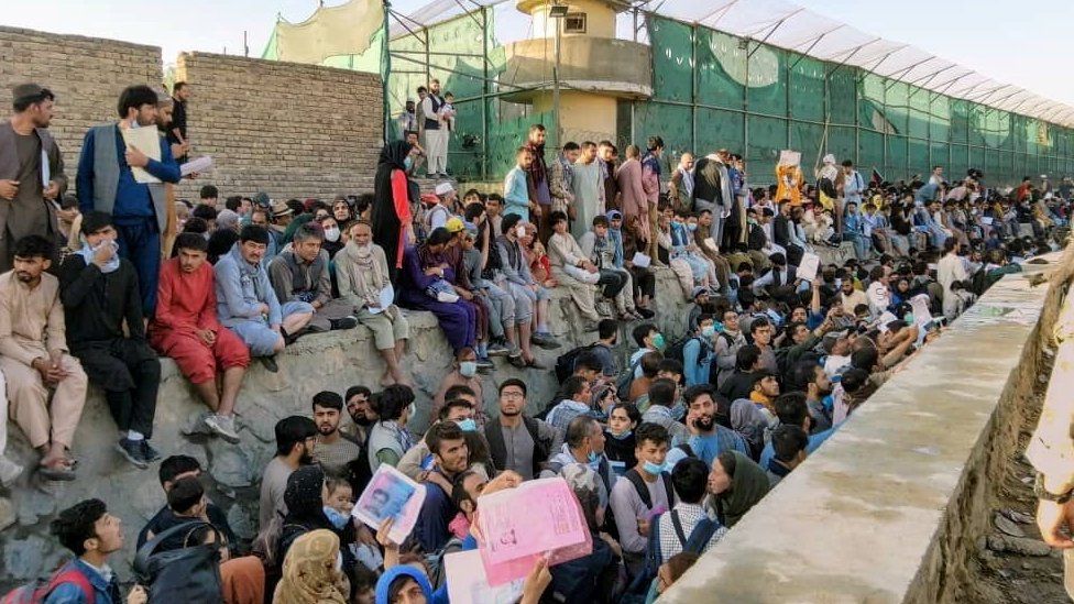 Crowds of people wait outside Kabul airport