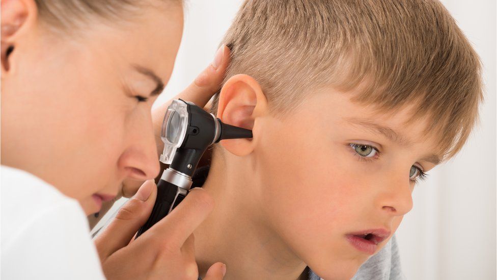 Boy having his ear examined