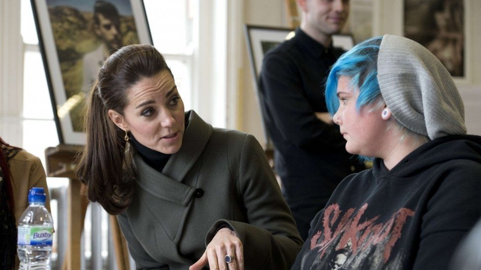 Duchess of Cambridge speaks to young people as she visits a photographic exhibition