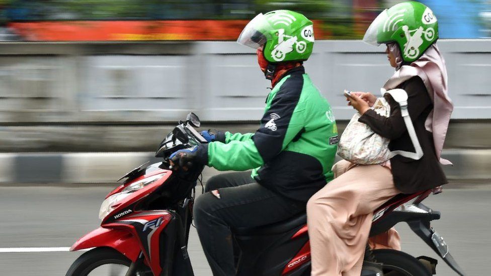 A GoJek rider and passenger in Jakarta