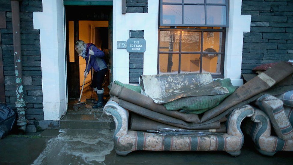 A Keswick householder cleans up after 2015's Storm Desmond