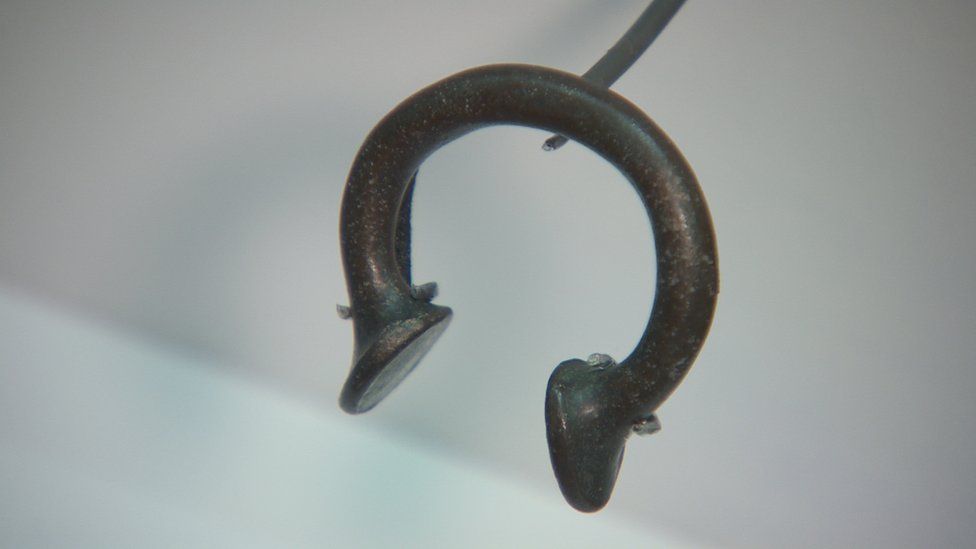 A bronze manilla or bracelet from West Africa was used as currency in the slave trade and features in the Ulster Museum exhibition