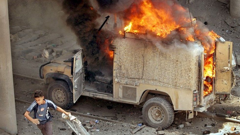 A British military vehicle on fire after a roadside bombing in Basra in May 2006
