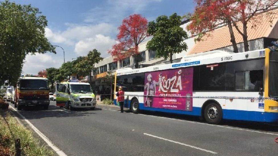 Emergency service vehicles line the street where the bus was set on fire