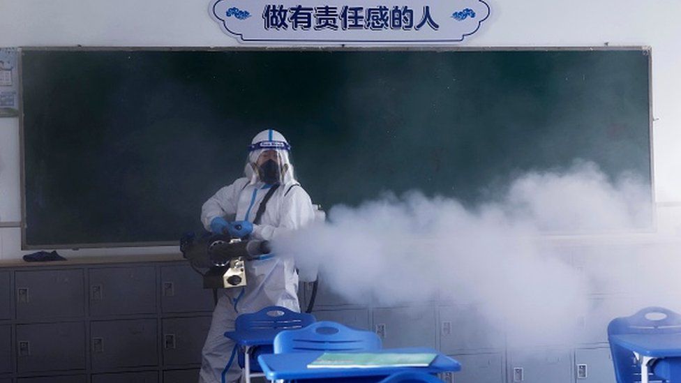 A man disinfects a classroom in Shanghai