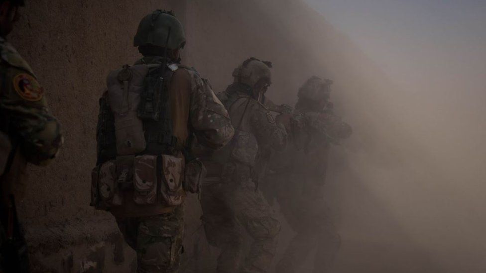 A group of Afghan soldiers, seemingly working at night