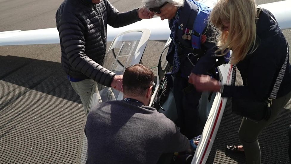 Mrs Orchard being helped into the glider
