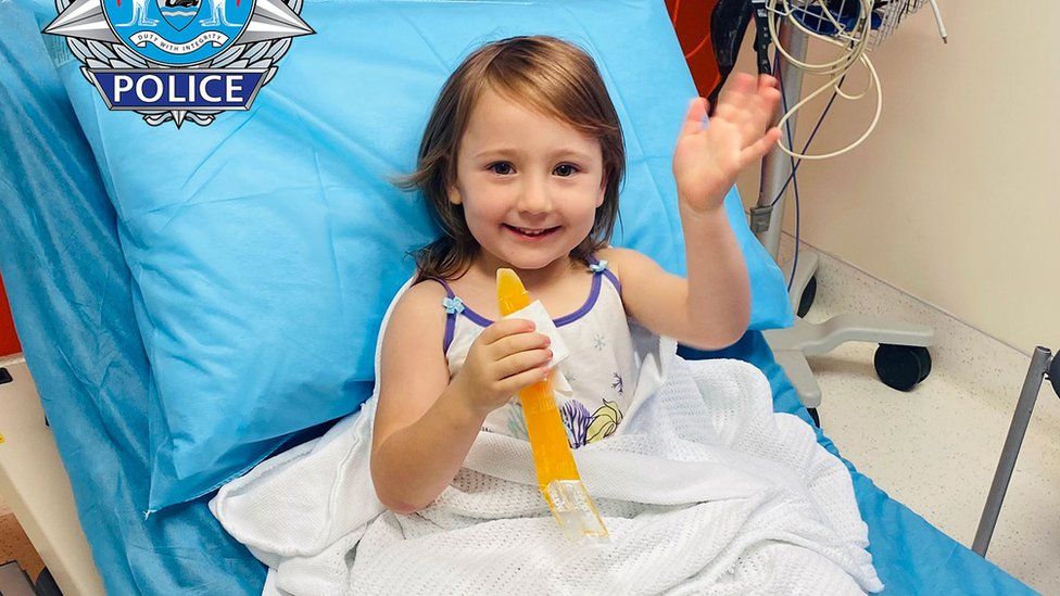 Cleo Smith waves from a hospital bed after her rescue