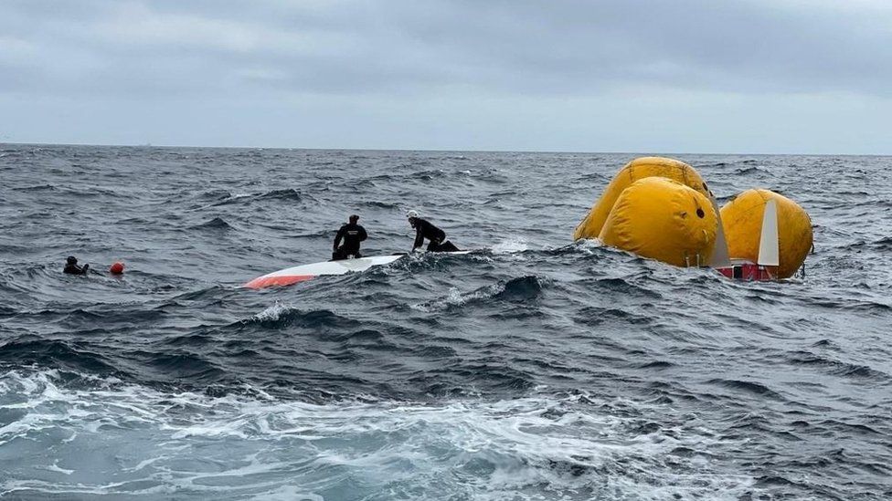 A Spanish crew from Salvamento Maritimo rescue a French sailor from under a capsized boat after 16 hours at sea off the coast of Malpica, A Coruna, in the Spanish north-western Galicia region, Spain August 2, 2022. Salvamento Maritimo/Handout via REUTERS THIS IMAGE HAS BEEN SUPPLIED BY A THIRD PARTY. MANDATORY CREDIT. NO RESALES. NO ARCHIVES