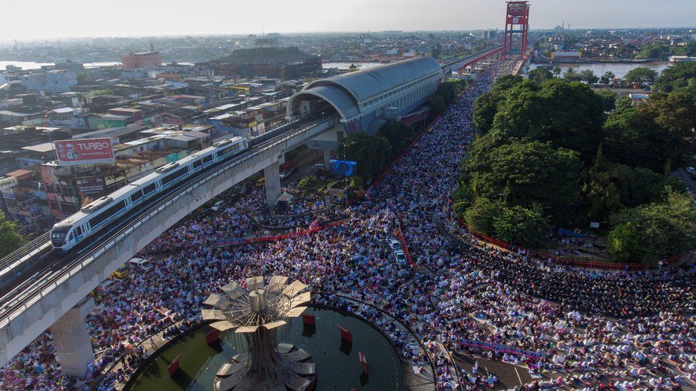 Drone view of Muslims attending mass prayers on the road in Palembang, Indonesia