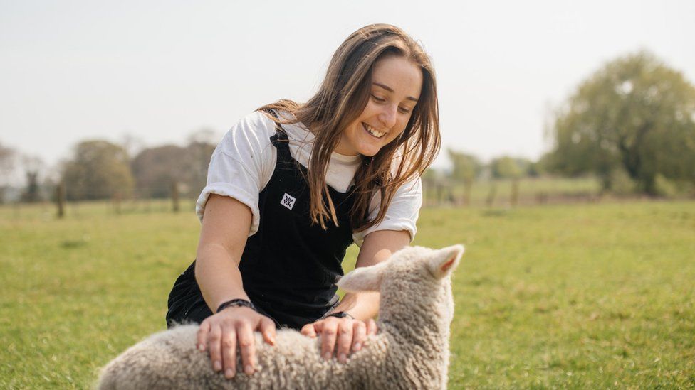 Anna Jackson with a lamb