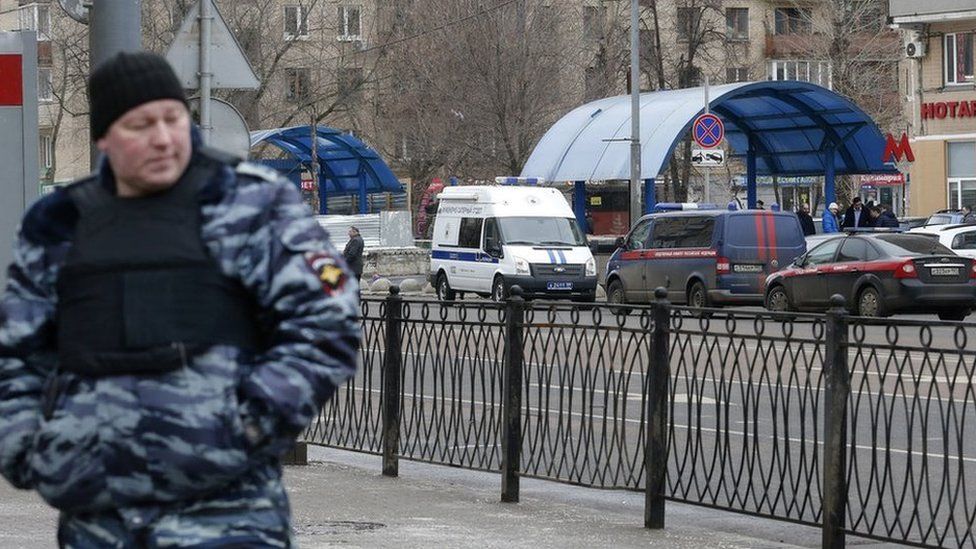 A policeman stands guards near the Moscow metro station where the beheading suspect was arrested, 29 February