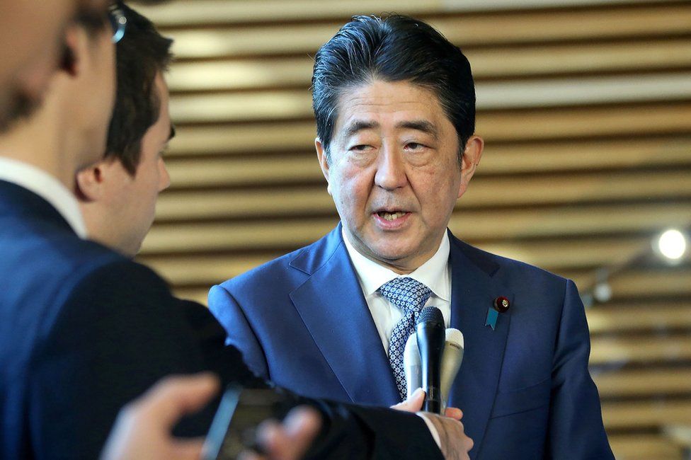Japanese Prime Minister Shinzo Abe answers questions after talking by phone to US President Donald Trump at his official residence in Tokyo, 29 November
