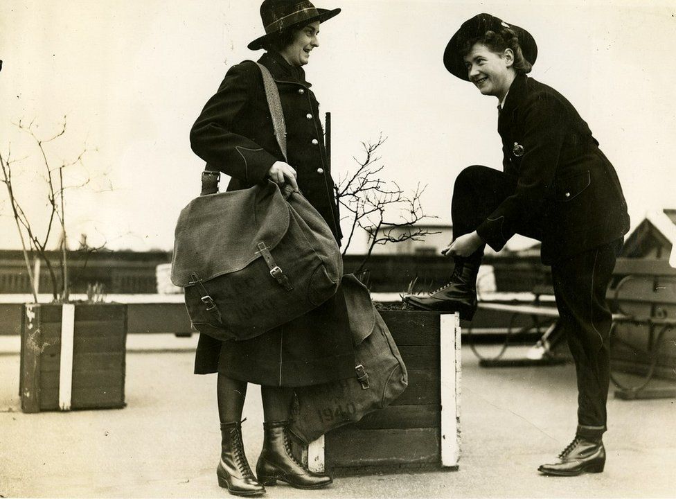 Two postwomen in 1941, one of whom is wearing trousers