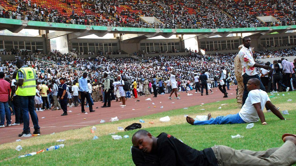 Job-seekers lie on the pitch after a stampede in Abuja National Stadium, where thousands of job-seekers came to apply for work at the Nigerian immigration department, in Abuja, on March 15, 2014