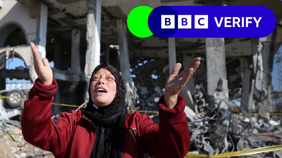 A Palestinian woman in front of a destroyed building in the Al-Maghazi refugee camp in the central Gaza Strip on January 16, 2024,