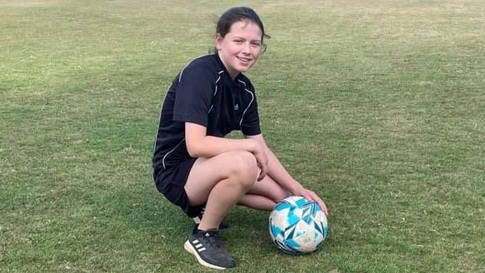 Lacey with a football