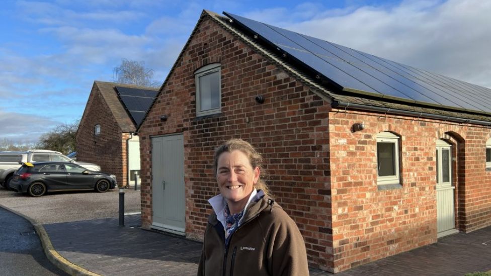 Amy Wheelton stands by her solar panels
