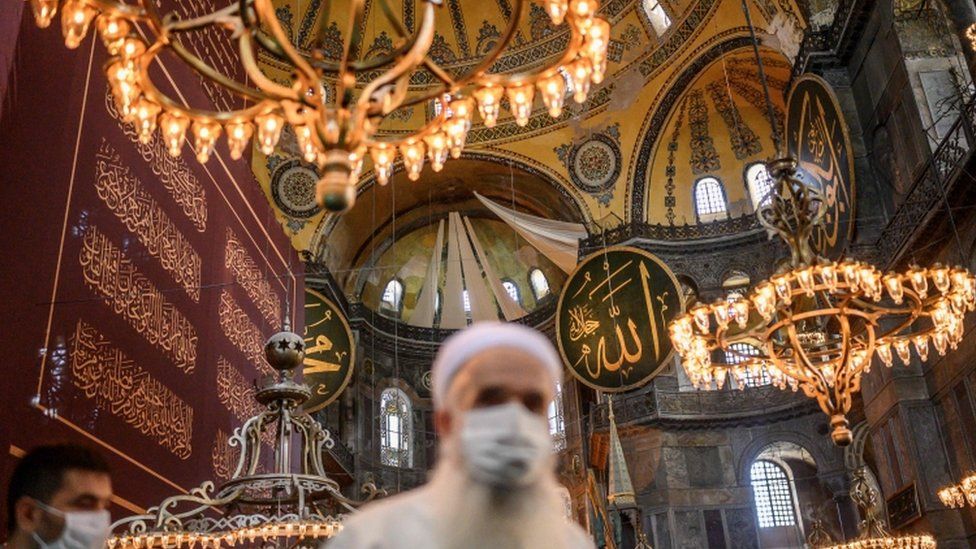 Christian mosaics and frescoes in Hagia Sophia's semi-domes were covered with white drapes