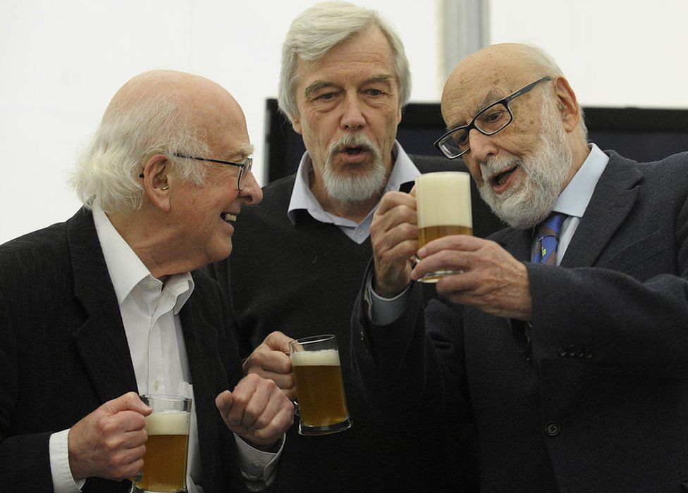 Scientists Belgian Francois Englert (r), British Peter Higgs (l) and director general of CERN, German Rolf Heuer (c) drink beers after a meeting with students of the Faculty of Science in Oviedo, on October 24, 2013,