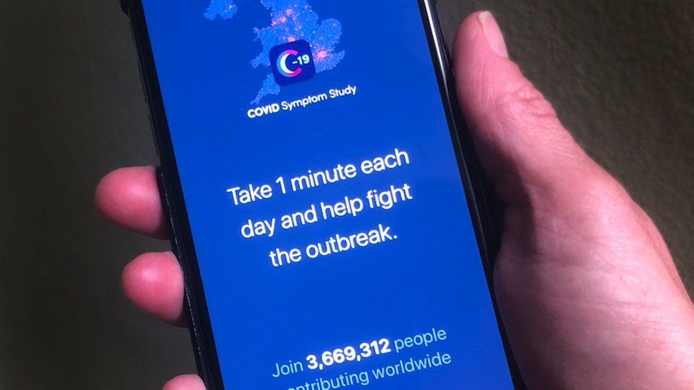 A person holding a phone displaying the Covid-19 Symptom Study App