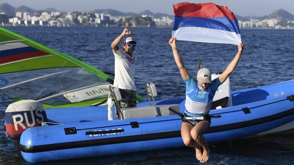 Russia's Stefaniya Elfutina celebrates after competing in the RS:X Women sailing race on Guanabara Bay in Rio de Janerio during the Rio 2016 Olympic Games on August 14, 2016