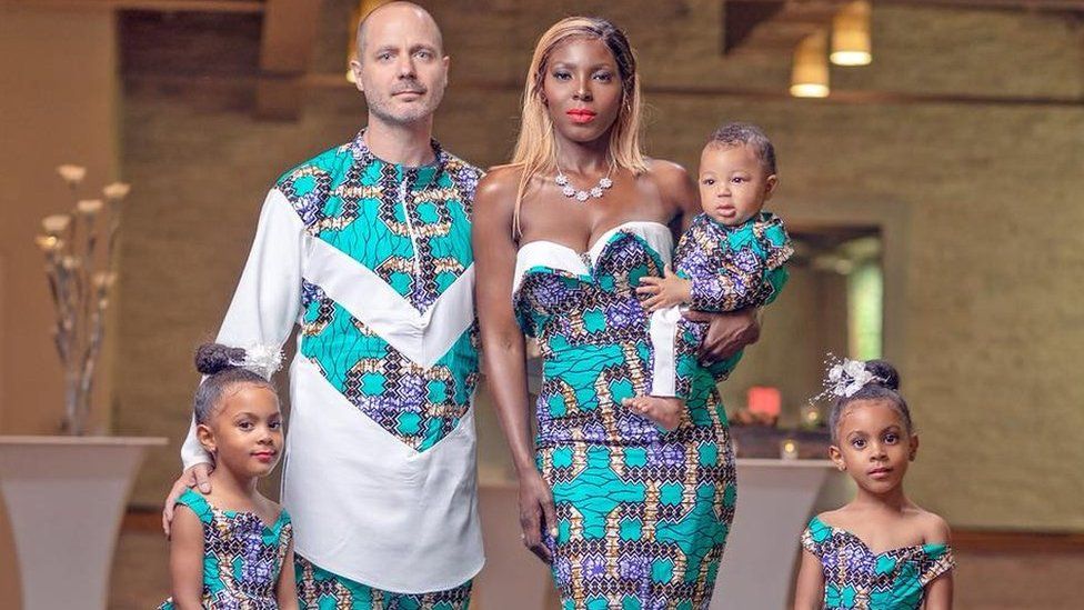 Justin and Aminat McClure pose in clothes inspired by West Africa with their twin daughters and son