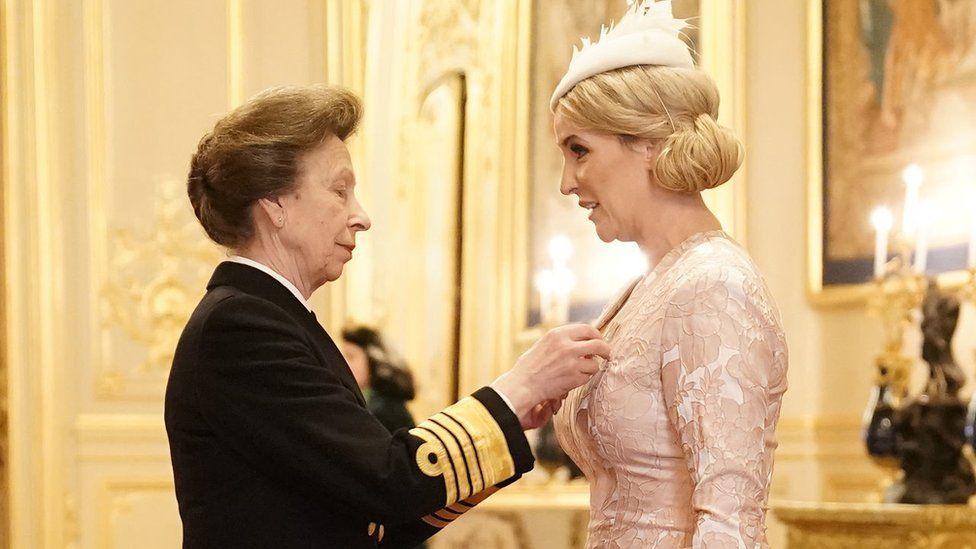 Princess Royal pinning an award on Lizzie Jones in Windsor Castle
