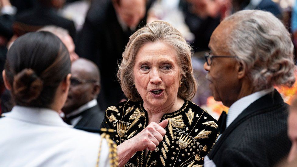 Hillary Clinton (C), former US secretary of state, speaks with Reverend Al Sharpton (R), founder and president of the National Action Network, during a state dinner at the White House in Washington, DC, US, 23 May 2024.