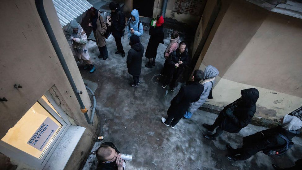 People queue in a street courtyard at the campaign headquarters of the Civil Initiative party's presidential candidate, Boris Nadezhdin, to sign their support for the candidate