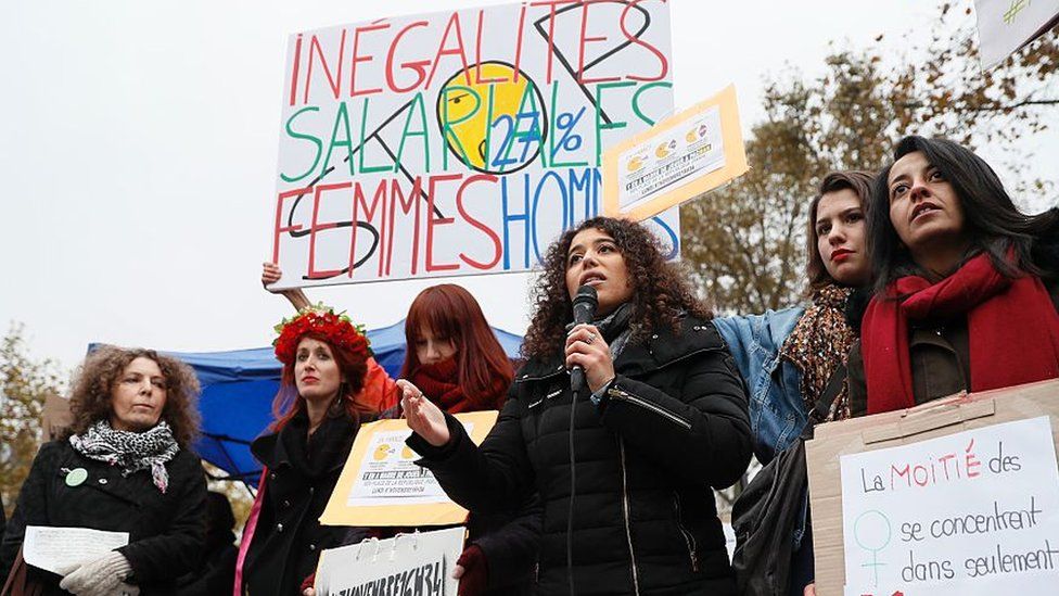 Women stage a protest over pay inequality at the place de republique