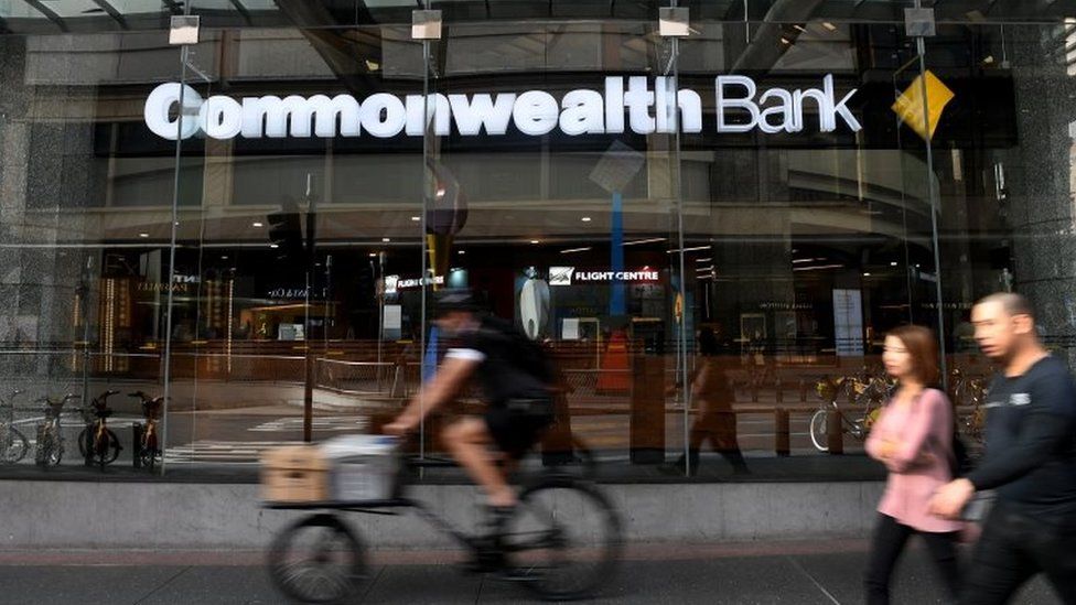 Pedestrians walk past a Commonwealth Bank branch