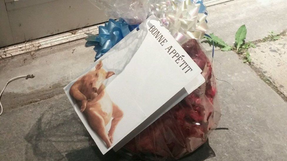 a "gift-wrapped" pig's head with a mock greetings card reading "bonne appetit" - posted to the centre's Facebook page last year