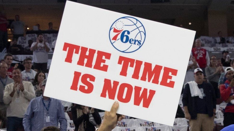 76ers fan holds placard