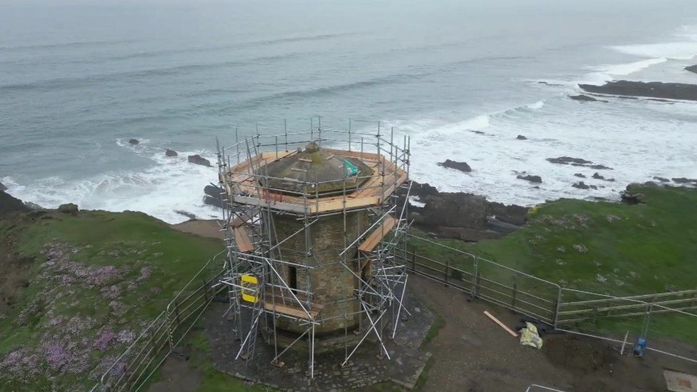 The Bude watertower beside the cliff edge, with scaffolding around it