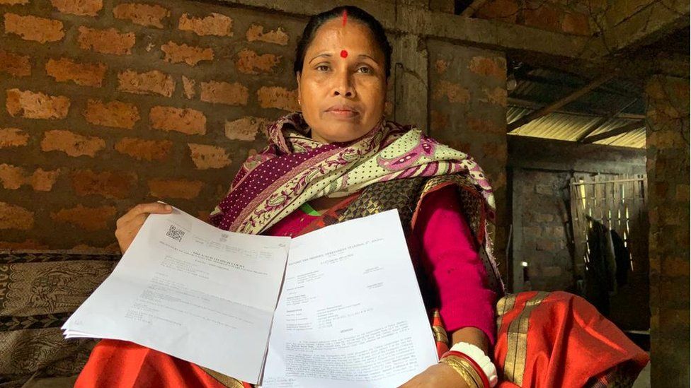 Sefali Rani Das holding up documents to prove her Indian citizenship.