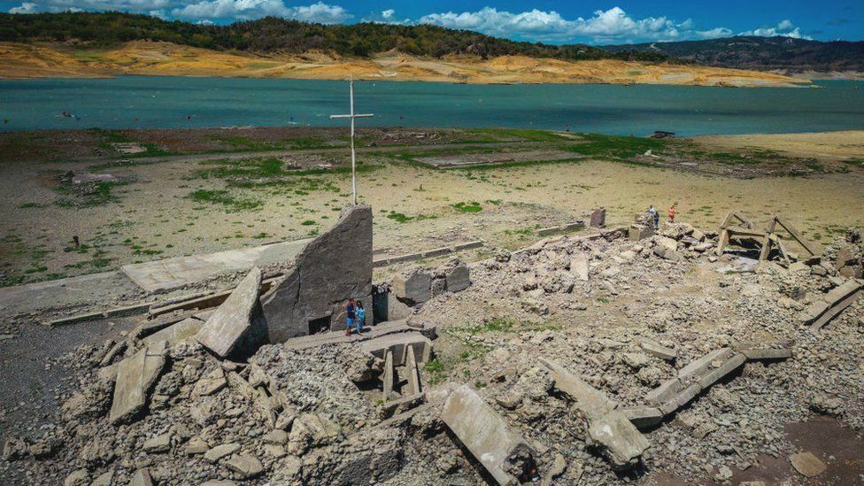 An aerial presumption    of the aged  sunken municipality  of Pantabangan connected  April 28, 2024 successful  Nueva Ecija province, Philippines. Due to a terrible  drought successful  the Philippines, a centuries-old colony  submerged since the 1970s has reemerged, attracting tourists contempt  the utmost  heat.