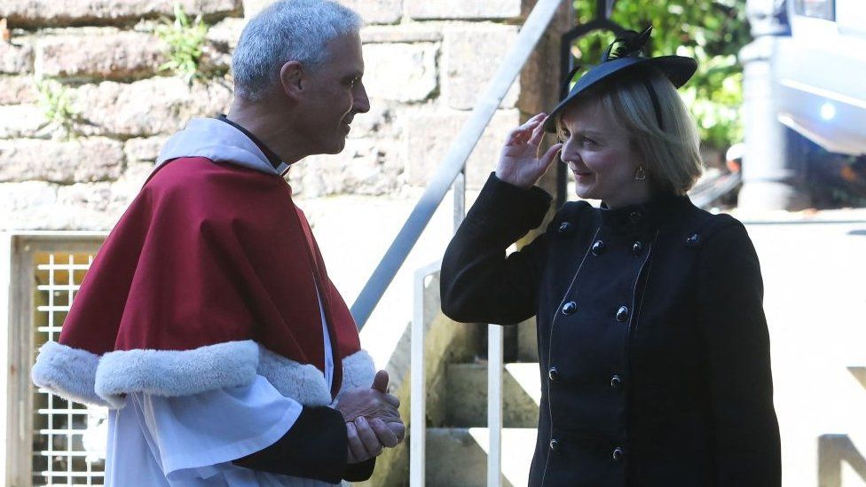 Britain's Prime Minister Liz Truss is greeted by Dean of Llandaff Cathedral Michael Komor upon her arrival for a Service of Prayer and Reflection for the life of Queen Elizabeth II