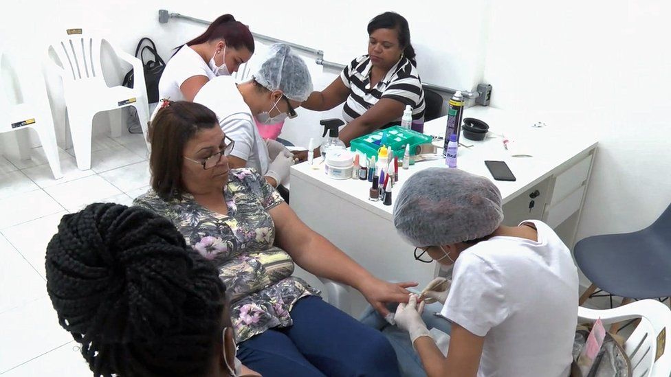 Clients and staff in beauty parlour