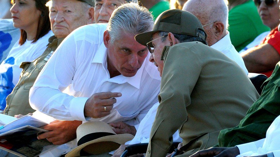 Cuban President Raul Castro (R) talking to First Vice President Miguel Diaz Canel (L),