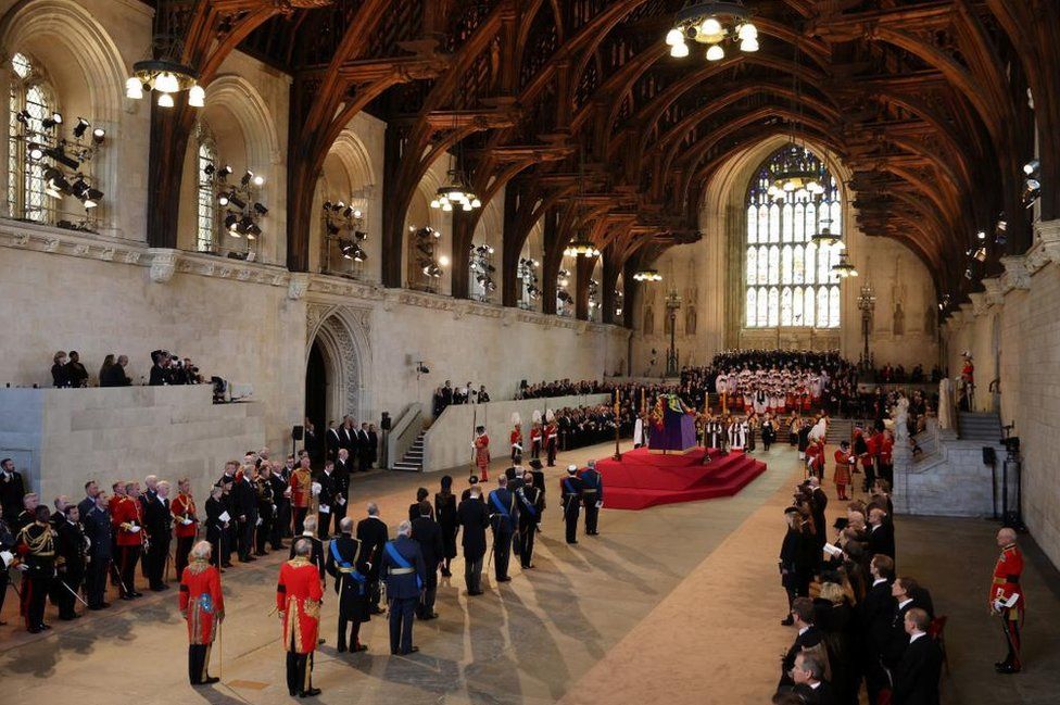 The Royal Family stand behind the coffin in Westminster Hall
