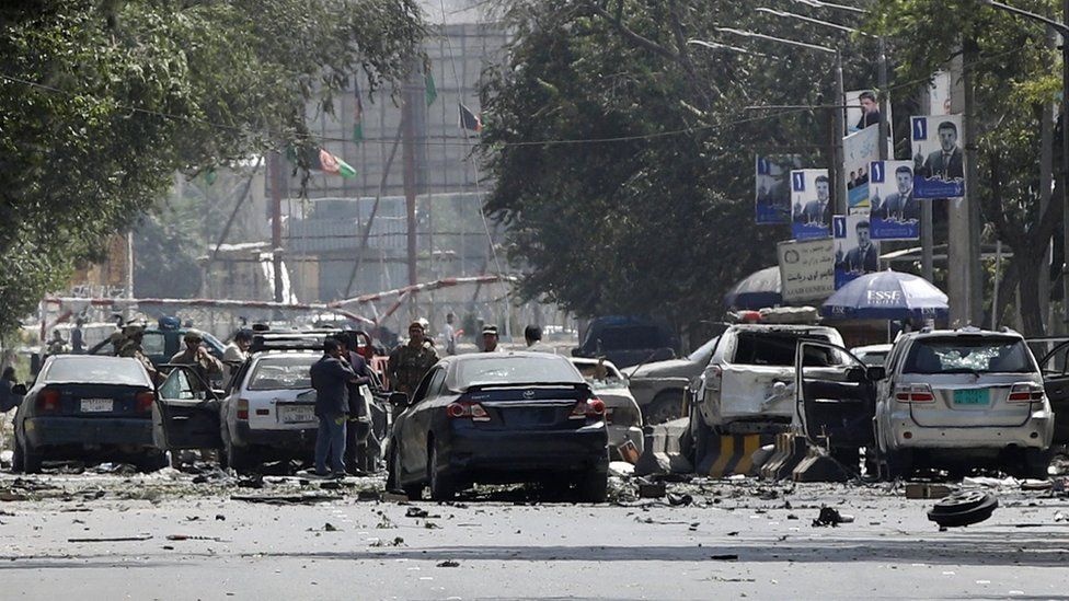 Afghan security forces inspect the scene after a suicide attack targeted a checkpoint in downtown Kabul