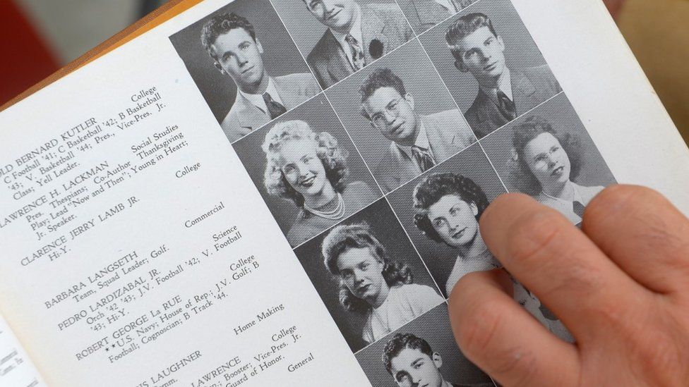 A person flicks through an old high school yearbook