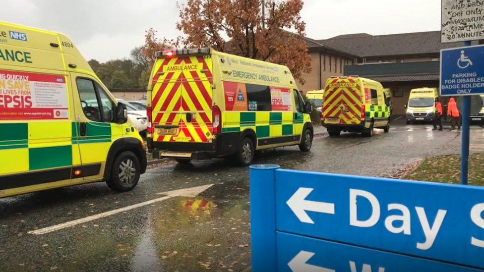 West Midlands Ambulance Service vehicles waiting outside a hospital
