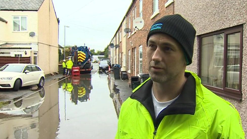 Jonathan Edwards outside his flooded home