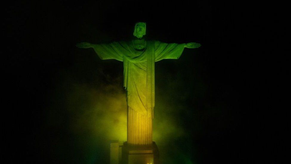 The Christ The Redeemer statue in Rio de Janeiro is illuminated in green and yellow, the colours of the Brazilian national flag, in honour of Brazilian football legend Pele