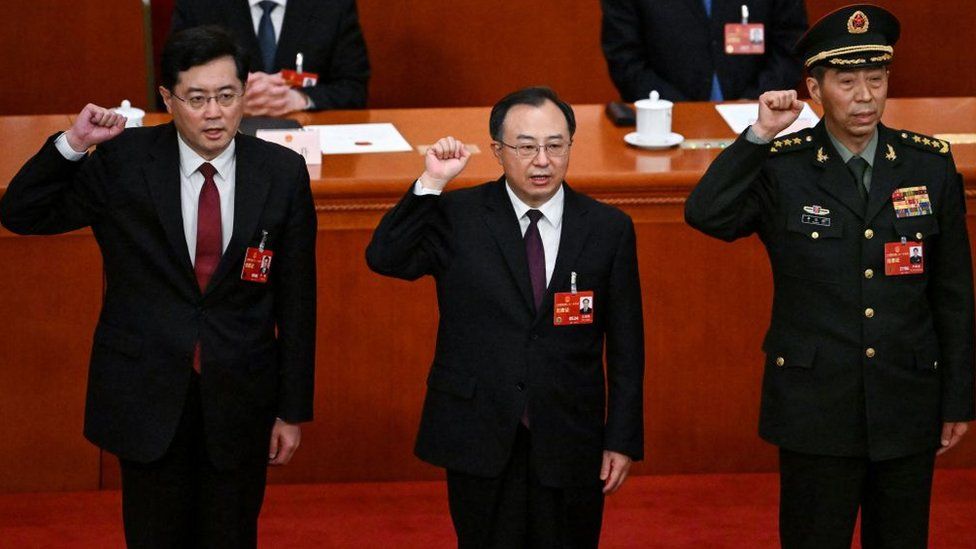 Newly-elected Chinese state councilor Qin Gang, state councilor and secretary-general of the State Council Wu Zhenglong, state councilor Li Shangfu swear an oath after they were elected during the fifth plenary session of the National People's Congress (NPC) at the Great Hall of the People in Beijing on March 12, 2023.