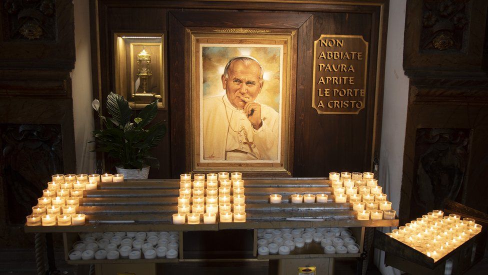 Candles and portrait of Pope John Paul II in the Cathedral of San Rufino in Assisi, Umbria, Italy