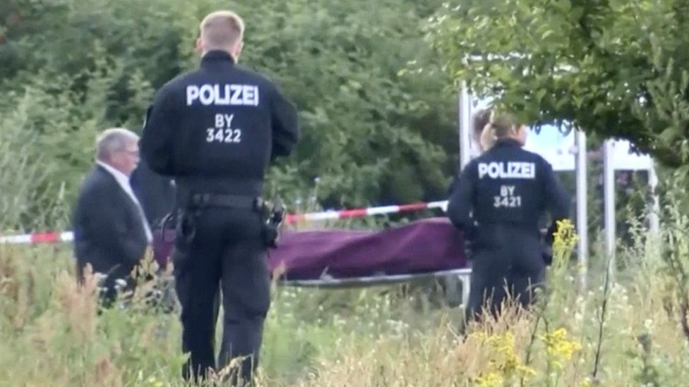 The body of the attacker is removed after he was shot dead fleeing the train