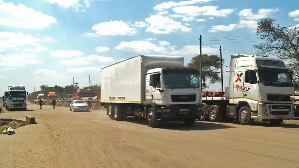 Convoys of trucks queuing outside a border post in Zambia